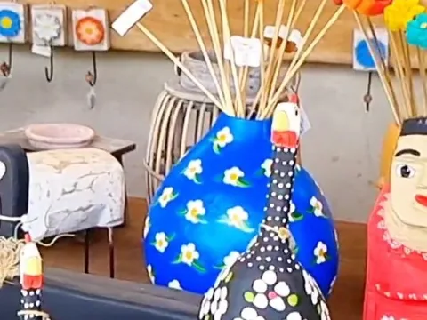 Peça de cerâmica pintada à mão em azul com flores